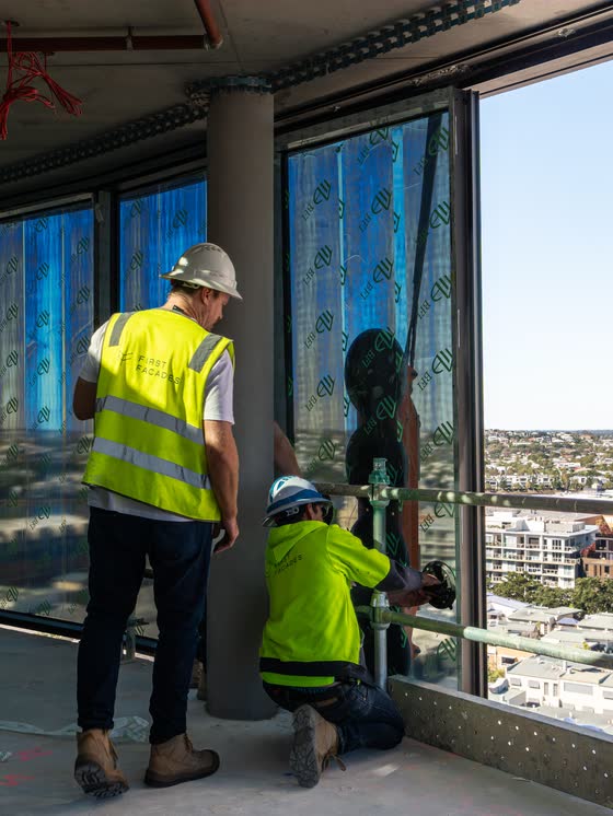 Glaziers installing windows on a high-rise